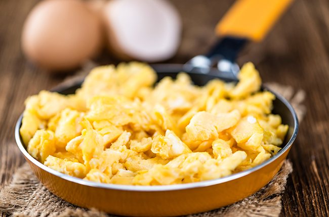 Scrambled Eggs (selective focus) on wooden background