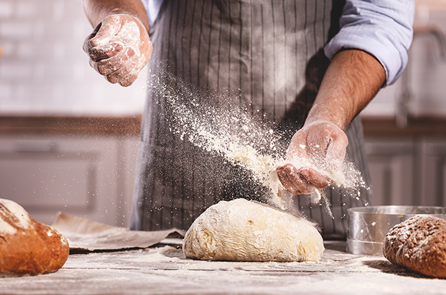 hands of baker’s male knead dough